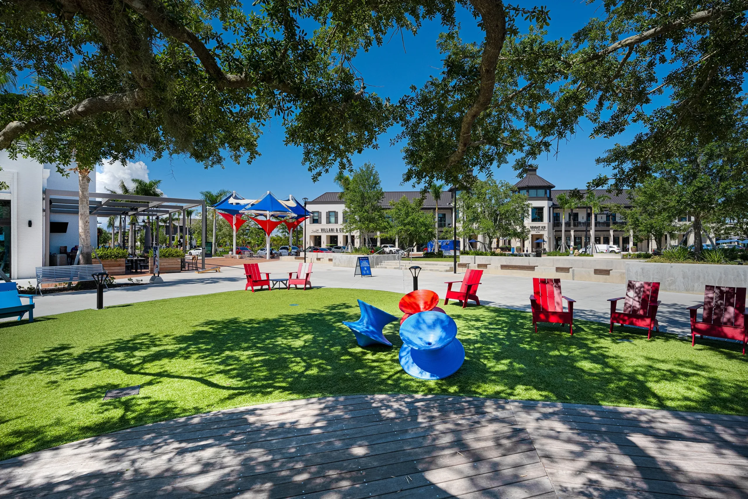 Vibrant community park in Venice, FL featuring colorful seating, shaded areas, and recreational amenities, highlighting the active lifestyle and social engagement available to residents.